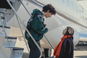 Vanya and Ani at the stairs of an airplane.
